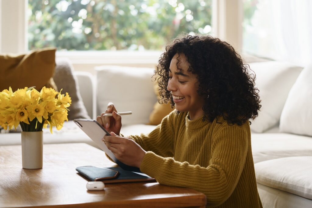 A photo of a smiley woman calculating personal finances and managing her Certificates of Deposits (CDs) and learning about its benefits.