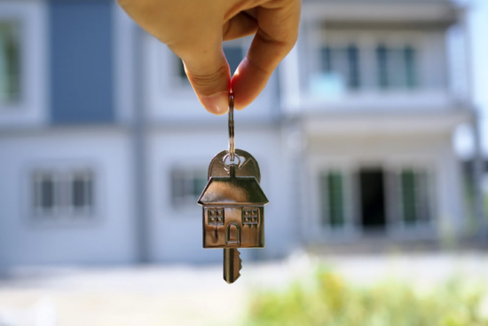 Understanding Mortgage Rates: Silver keys with home keychain in front of new home