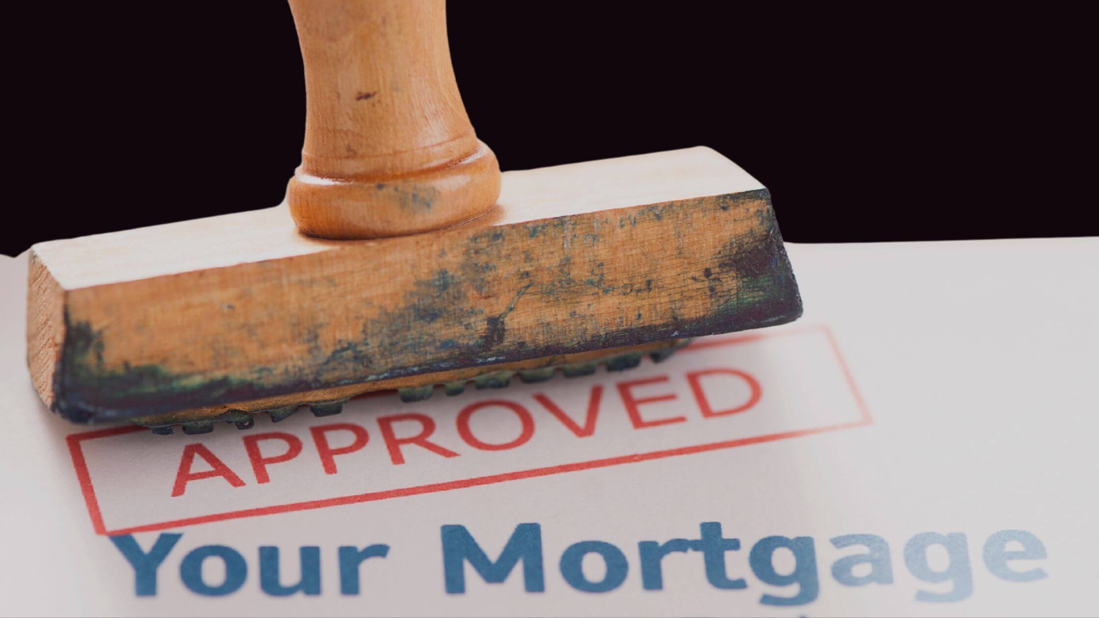 Approved rubber stamp on a mortgage document.