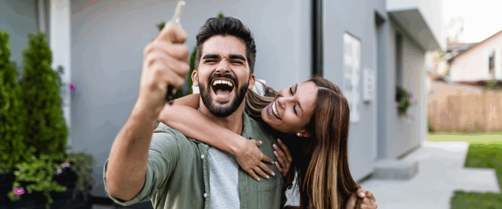Happy couple celebrating outside new Utah home after FHA loan approval