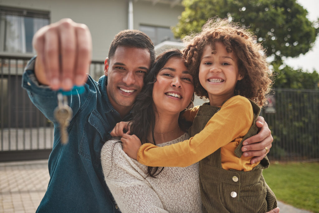 First-time homebuyer family standing in front of new Utah home