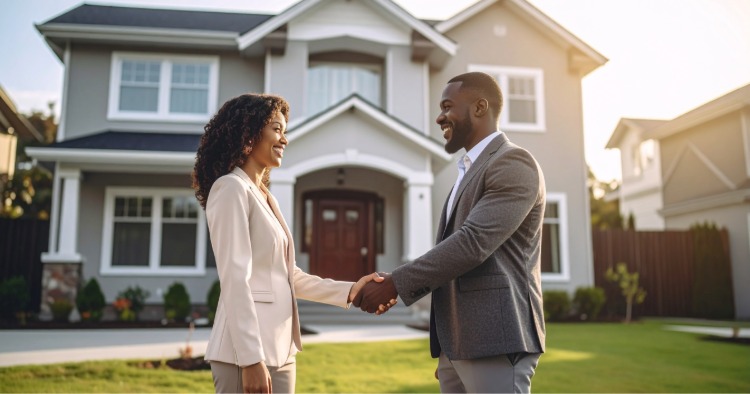 First time home buyer shaking hands with realtor